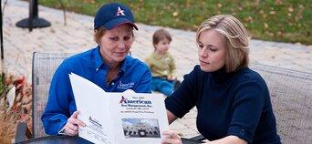Two women reading a pest control pamphlet