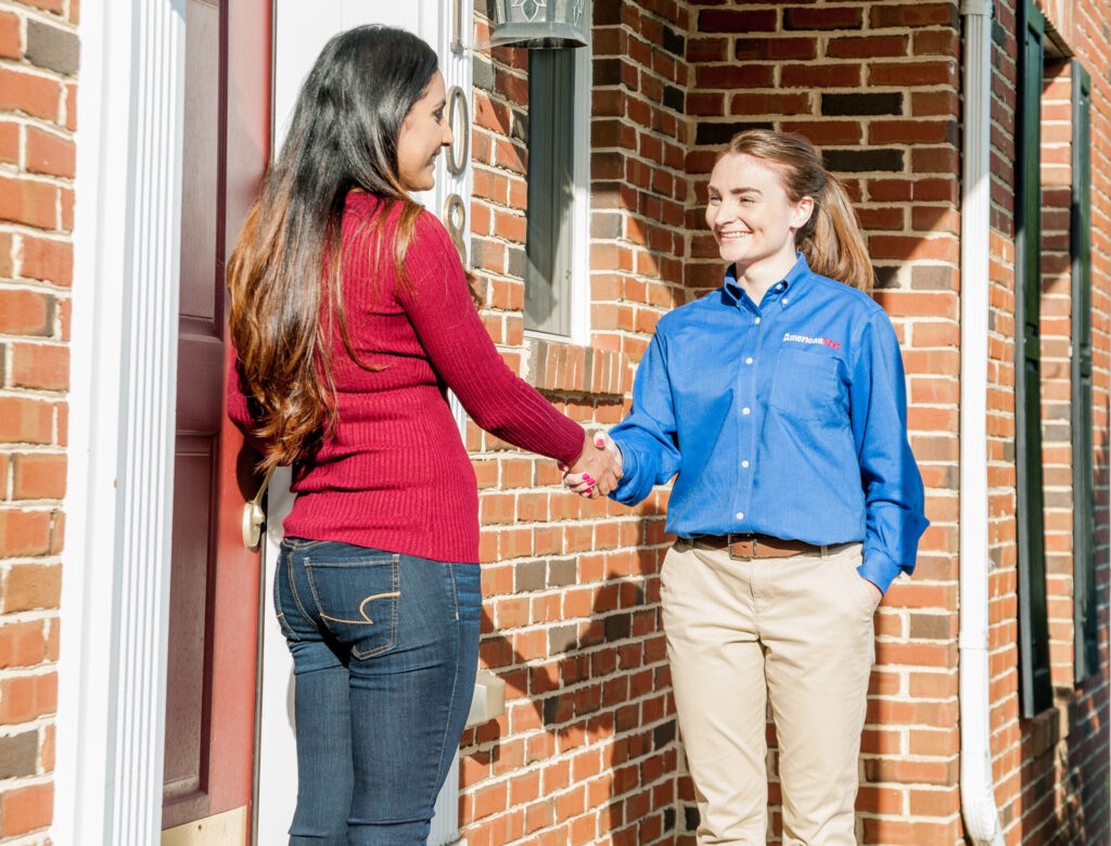 american pest employee shaking hands with customer