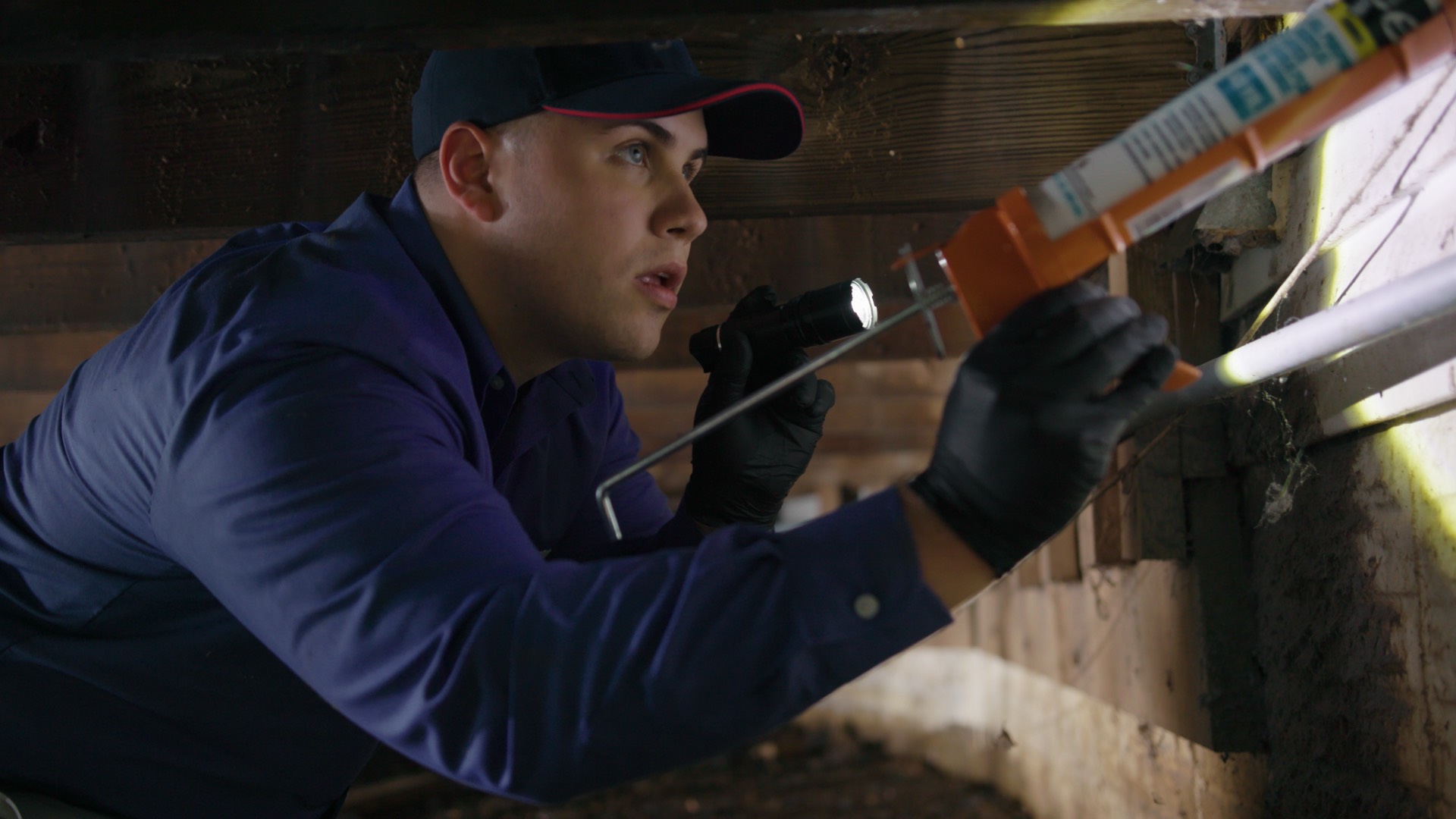 Man Sealing Exterior of Home