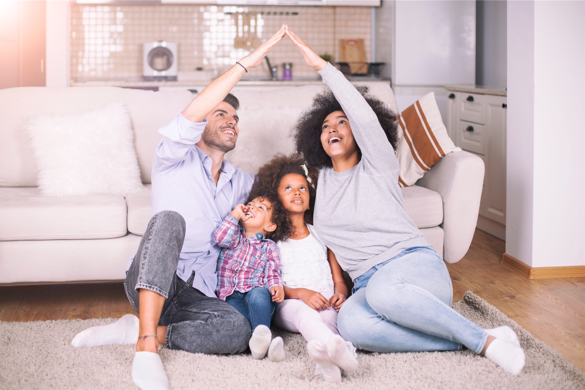 family making shape of a home protected by pest control