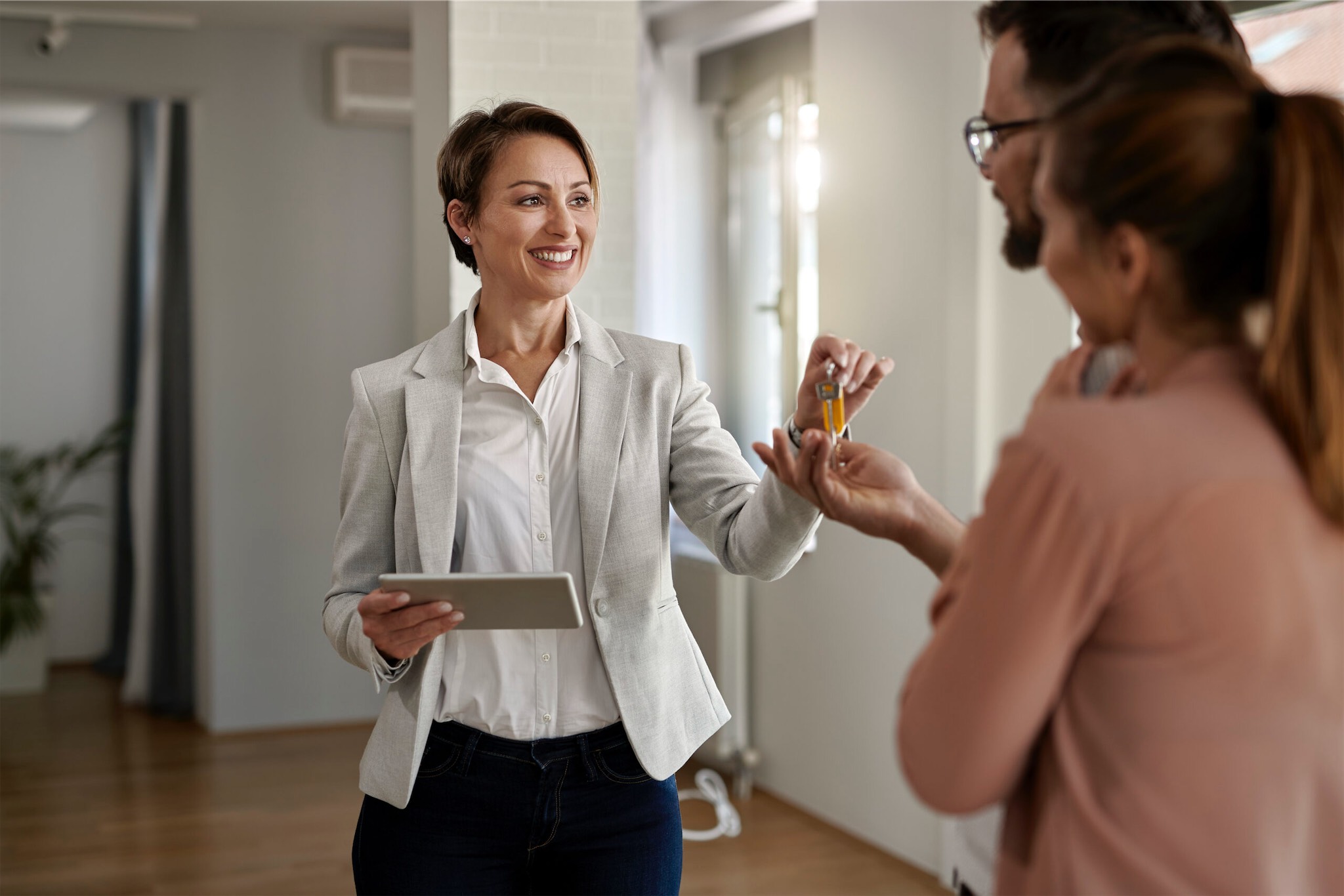 property manager handing keys to new tenants