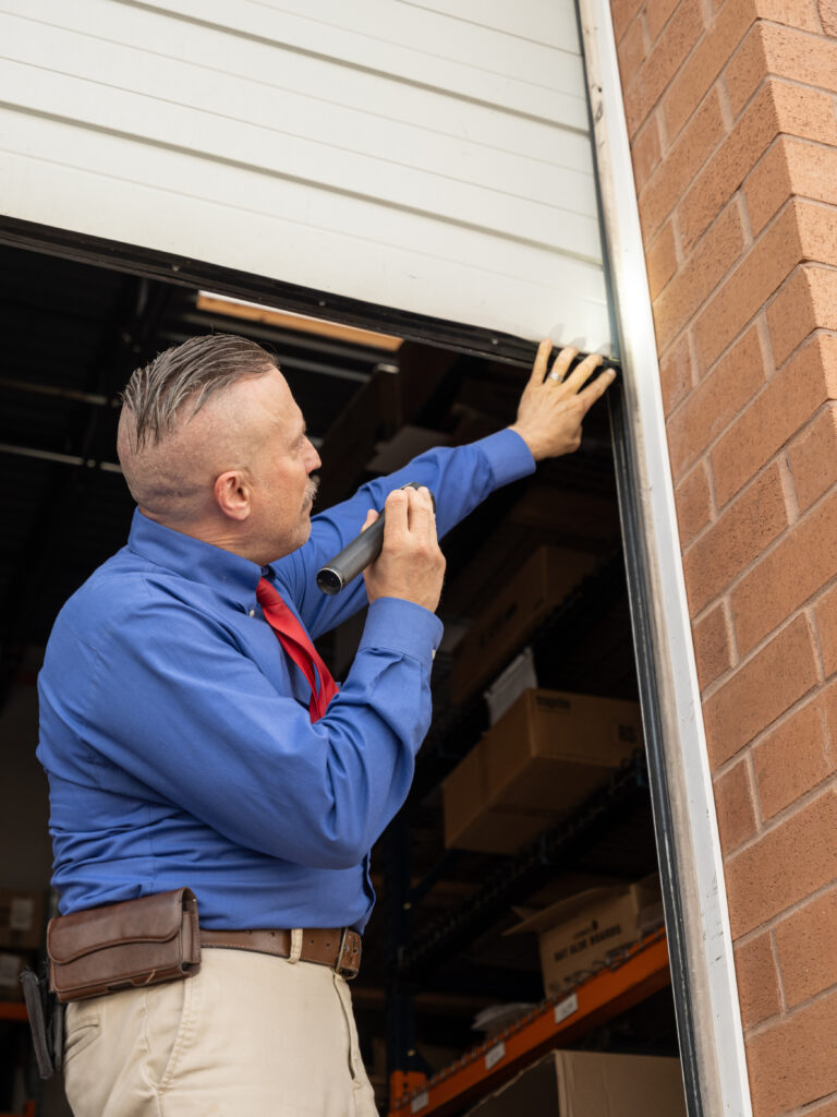American Pest technician inspecting garage door