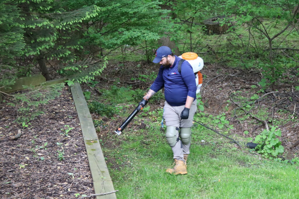 Leland Rudner applying mosquito, tick, and spotted lanternfly treatment
